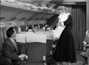Lucy smuggles a 30 lb. cheese onboard a plane disguised as a baby to avoid the excess baggage fee.